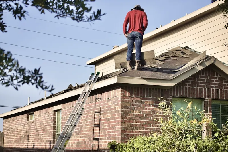 Professional roofer working on a residential roof in Point of Rocks Estates